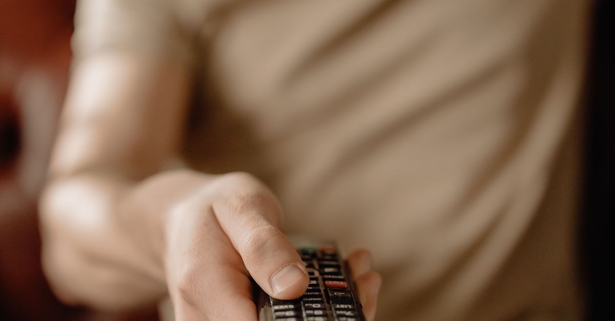 persons holding a red and black remote controllers ·... Person Holding Black Remote Control · Free Stock Photo