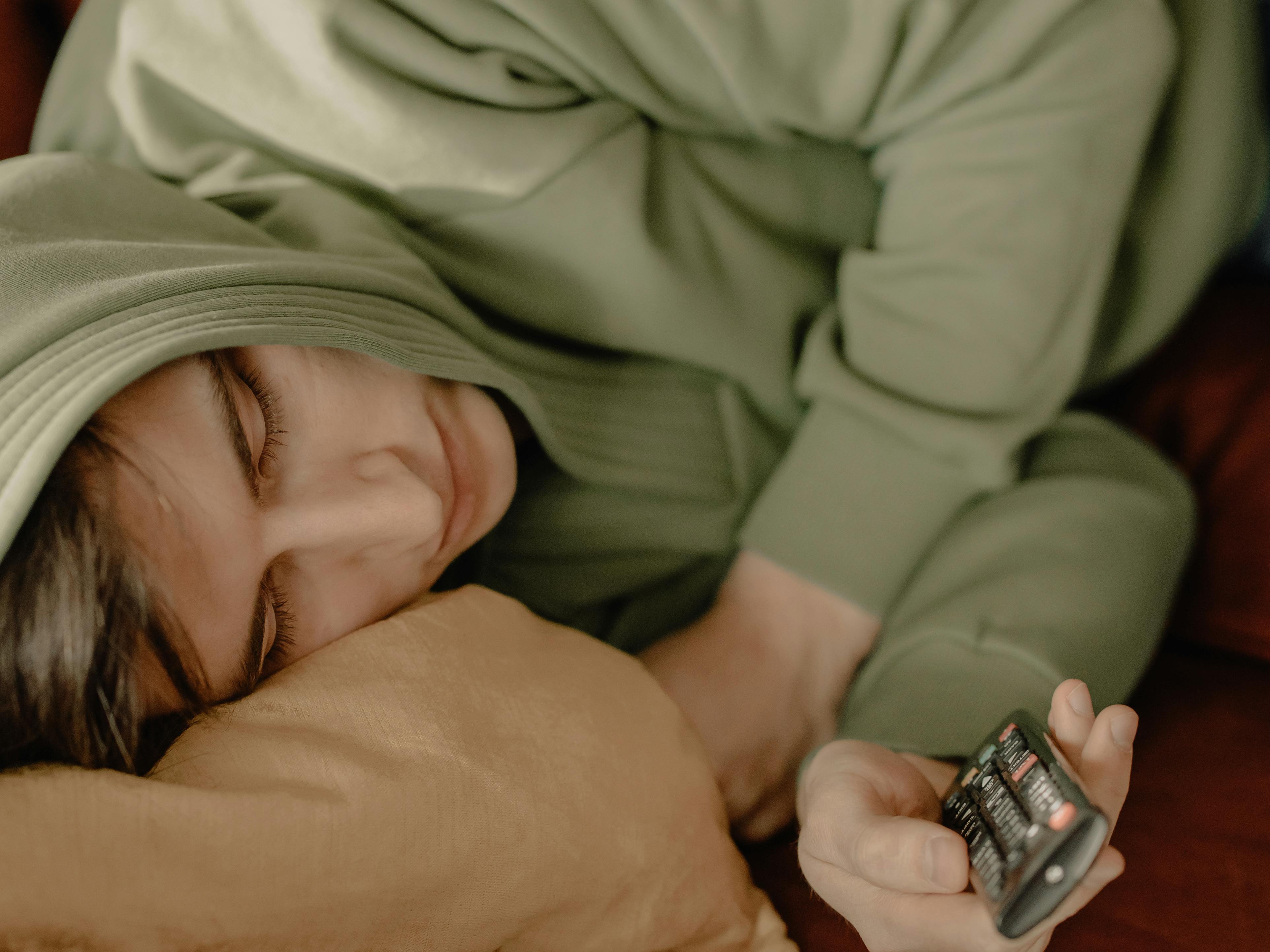 Person in Gray Shirt Lying on Bed · Free Stock Photo