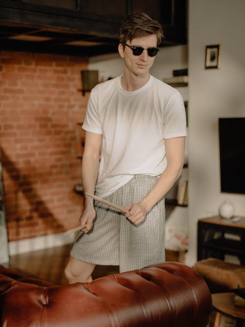 Free Man in White Crew Neck T-shirt and Black and White Striped Skirt Wearing Black Sunglasses Stock Photo