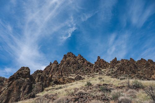Free Stunning rocky mountain landscape against a clear blue sky, perfect for travel and nature themes. Stock Photo