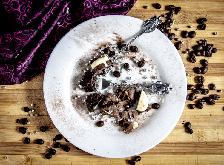 Chocolate Candy On White Ceramic Plate With Spoon And Fork