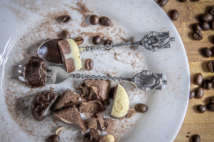 Chocolate Candy On White Ceramic Plate With Spoon And Fork