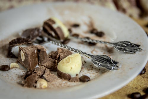 Chocolate Candy with Nut on White Ceramic Plate