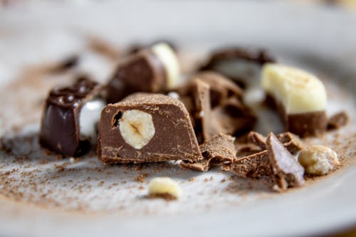 Chocolate Candy with Nuts on White Ceramic Plate