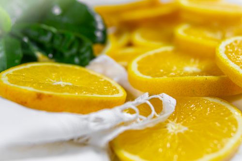 Free Close-up of juicy orange slices with green leaves, perfect for fresh food themes. Stock Photo