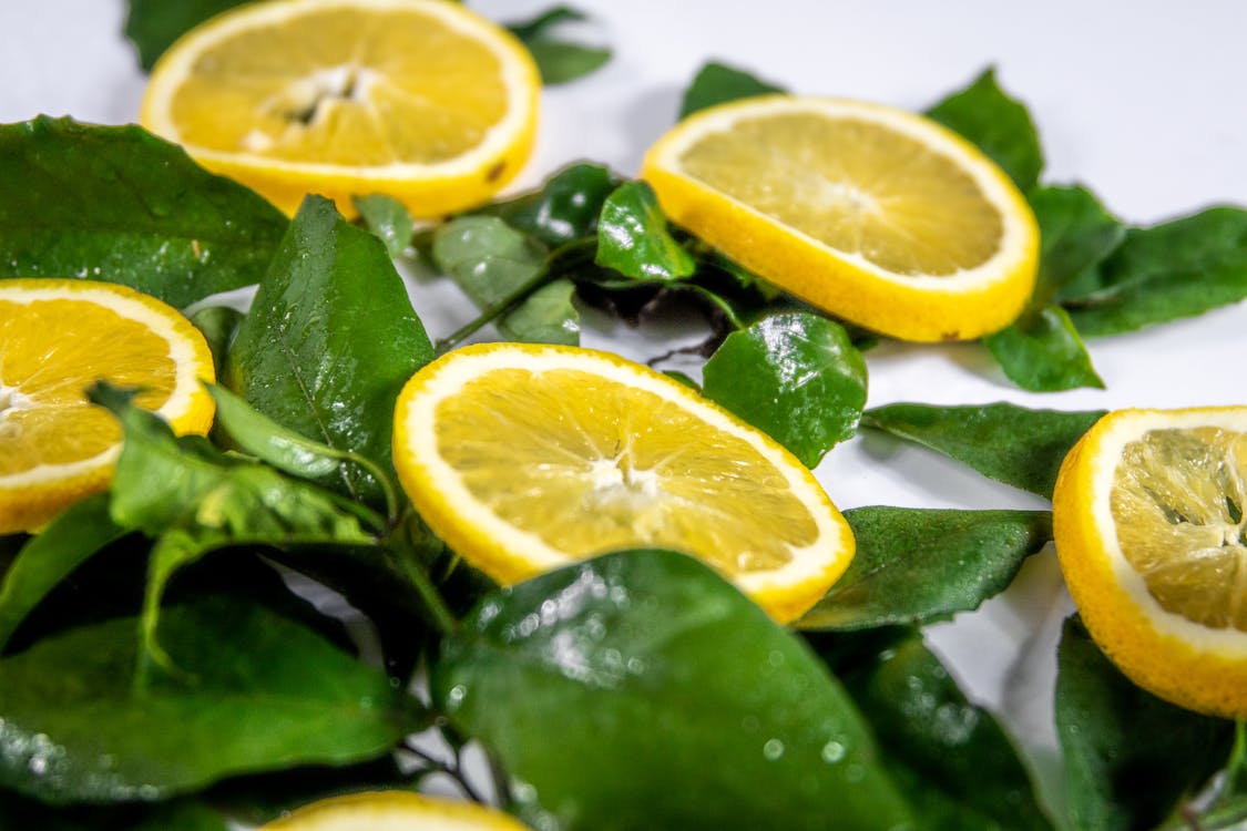 Sliced Lemon on Green Leaves
