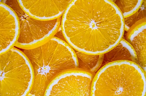 Free A close-up image showcasing fresh orange slices with vibrant colors and juicy textures. Stock Photo