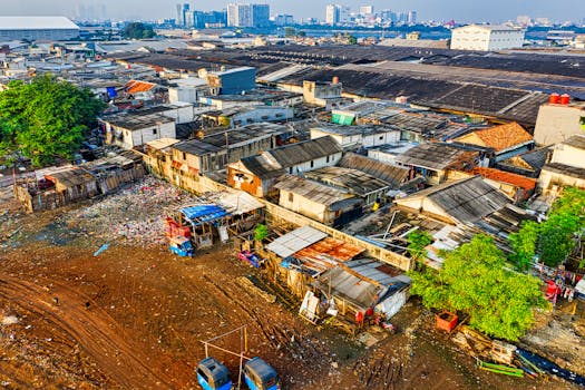 Aerial shot depicting urban slums in Jakarta with visible pollution and crowded housing.