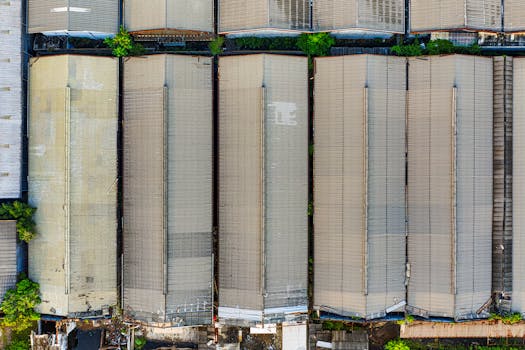 Aerial shot of large warehouses in Kecamatan Pademangan, Jakarta, showcasing industrial architecture.