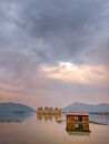 Ancient temple and stone monument covered with water placed in bay of tropical highlands