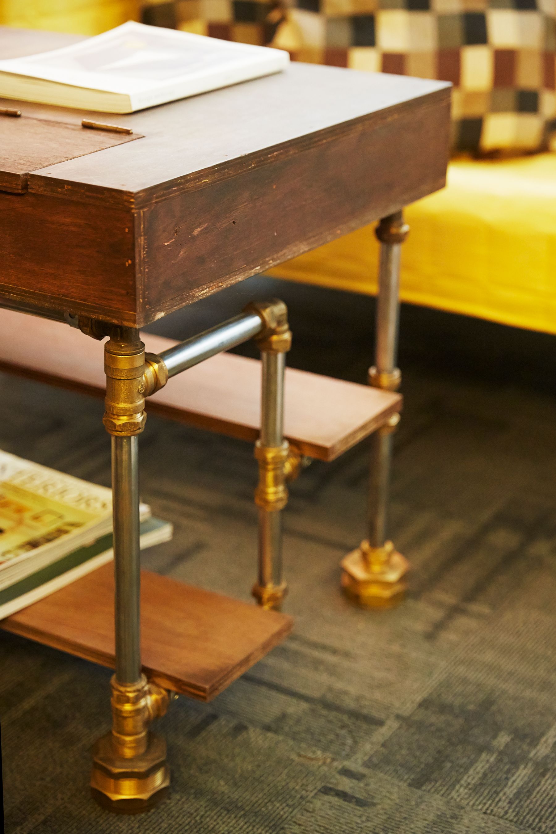 Substantial wood coffee table centered on a rug in front of upholstered seating