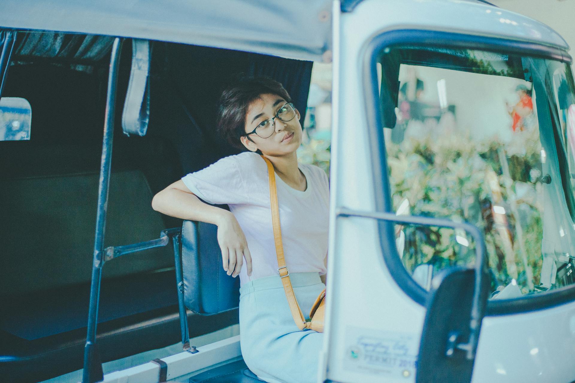A woman sitting in a tuk-tuk in Cavite City, Philippines, captured in warm daylight.