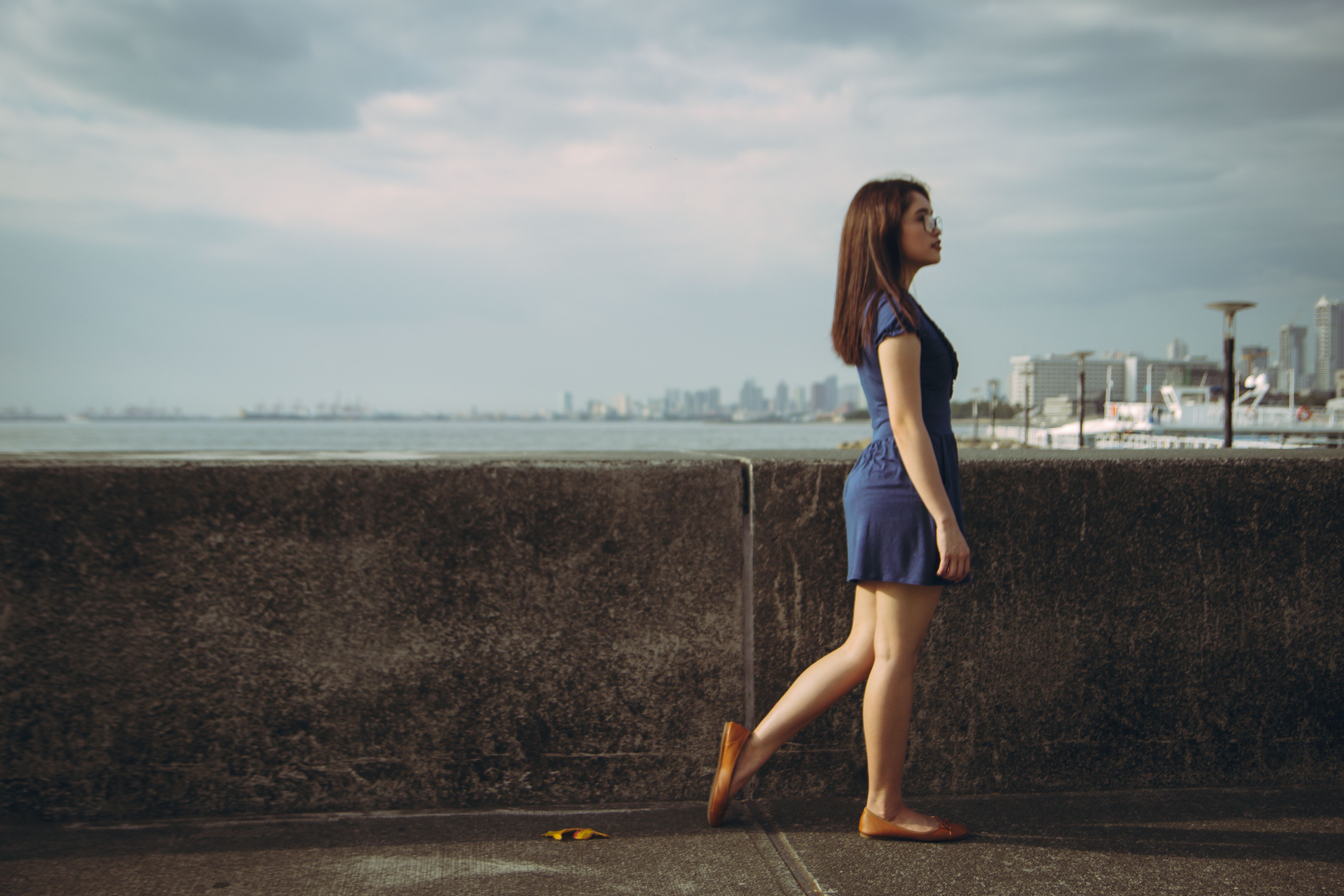 Woman in Blue Dress Standing on Gray Concrete Road · Free Stock Photo