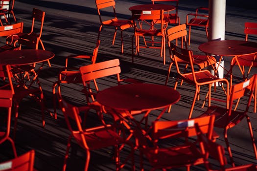 Red chairs and tables in a Vancouver outdoor dining space at daytime.