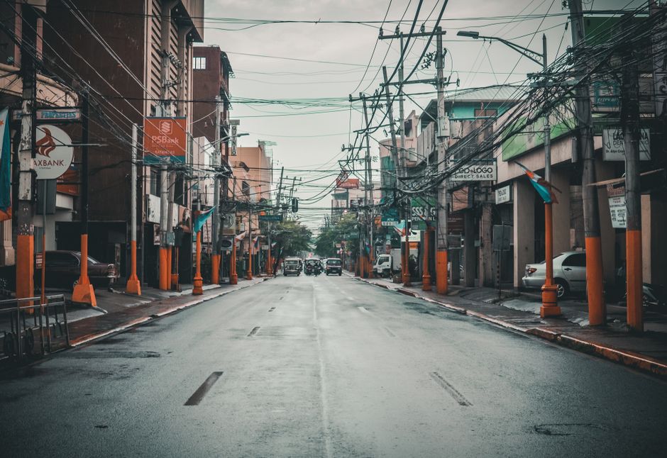 A bustling street in Manila during a light shower in the Philippines' wet season