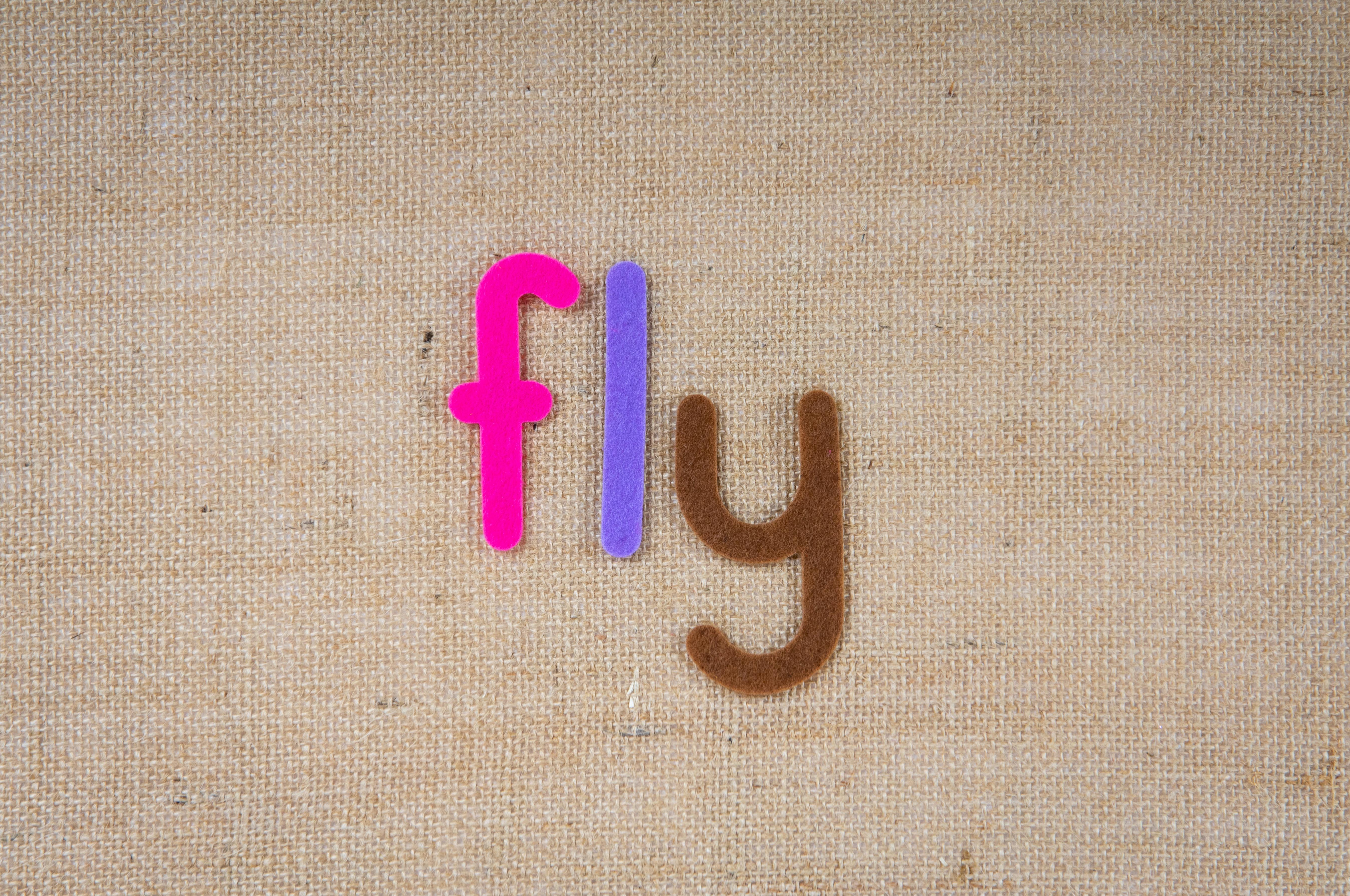 Colorful Letters on Brown Background · Free Stock Photo