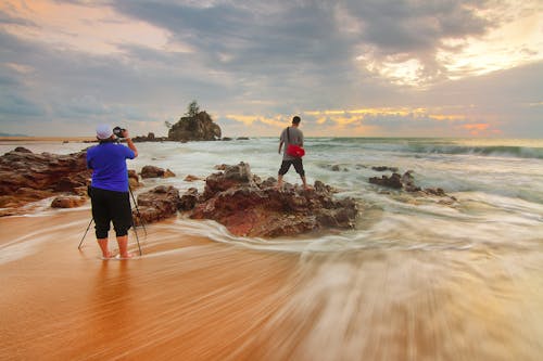 Man Standing on Brown Rock Formation