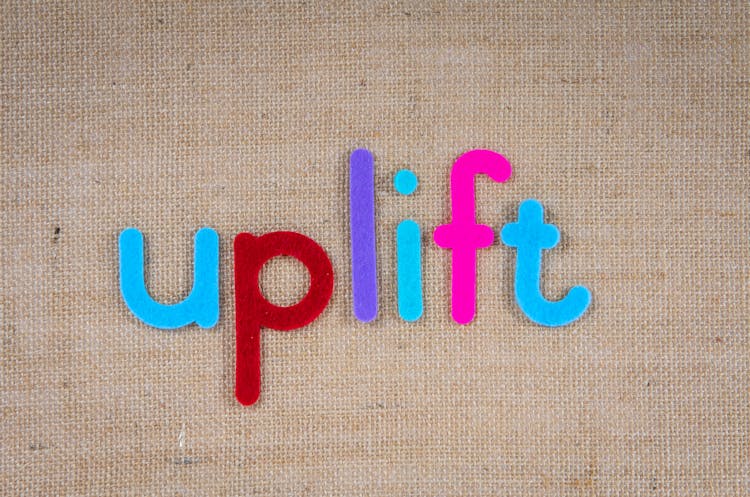 The Word Uplift On A Woven Surface