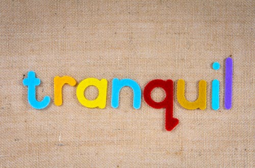 The Word Tranquil on a Woven Surface