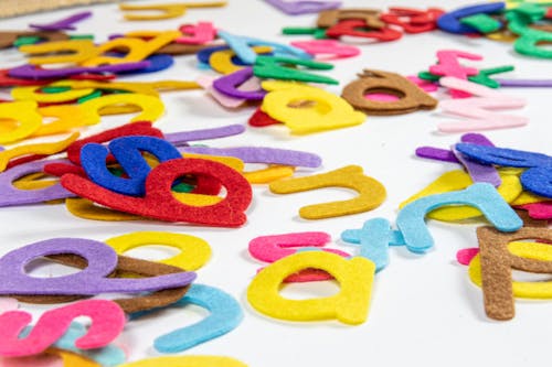 Free Colorful Cutouts Of Letters On Table Stock Photo