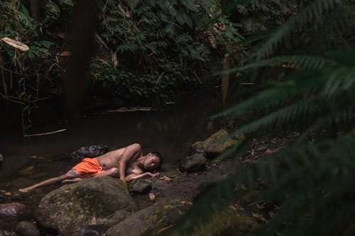 Photo Of Man Laying On Riverside