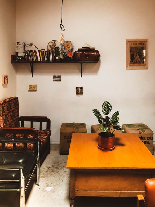 Free A cozy and rustic indoor living room with vintage decor, books, and a plant. Stock Photo