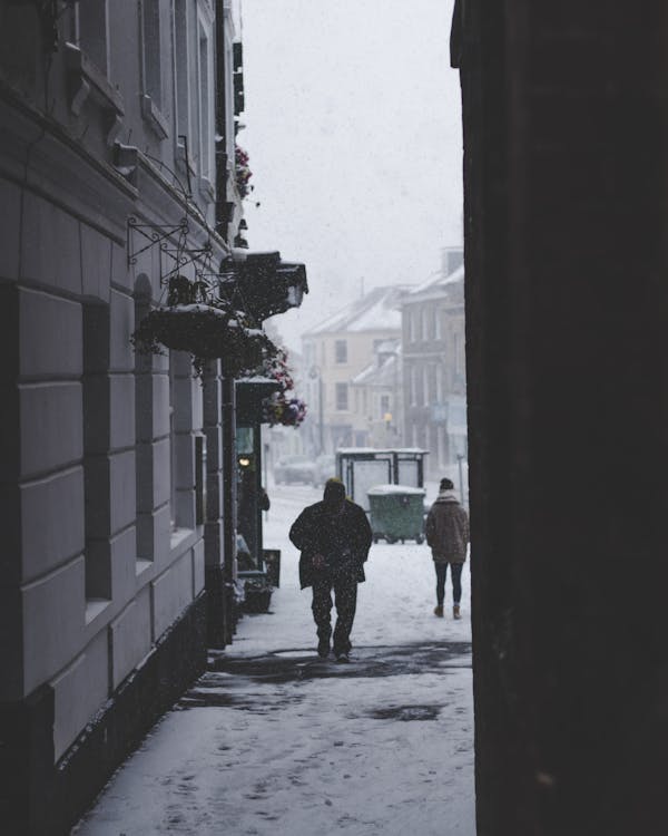 People Walking In The Street On A Snowy Day