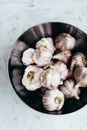 White Garlic on Black Round Bowl