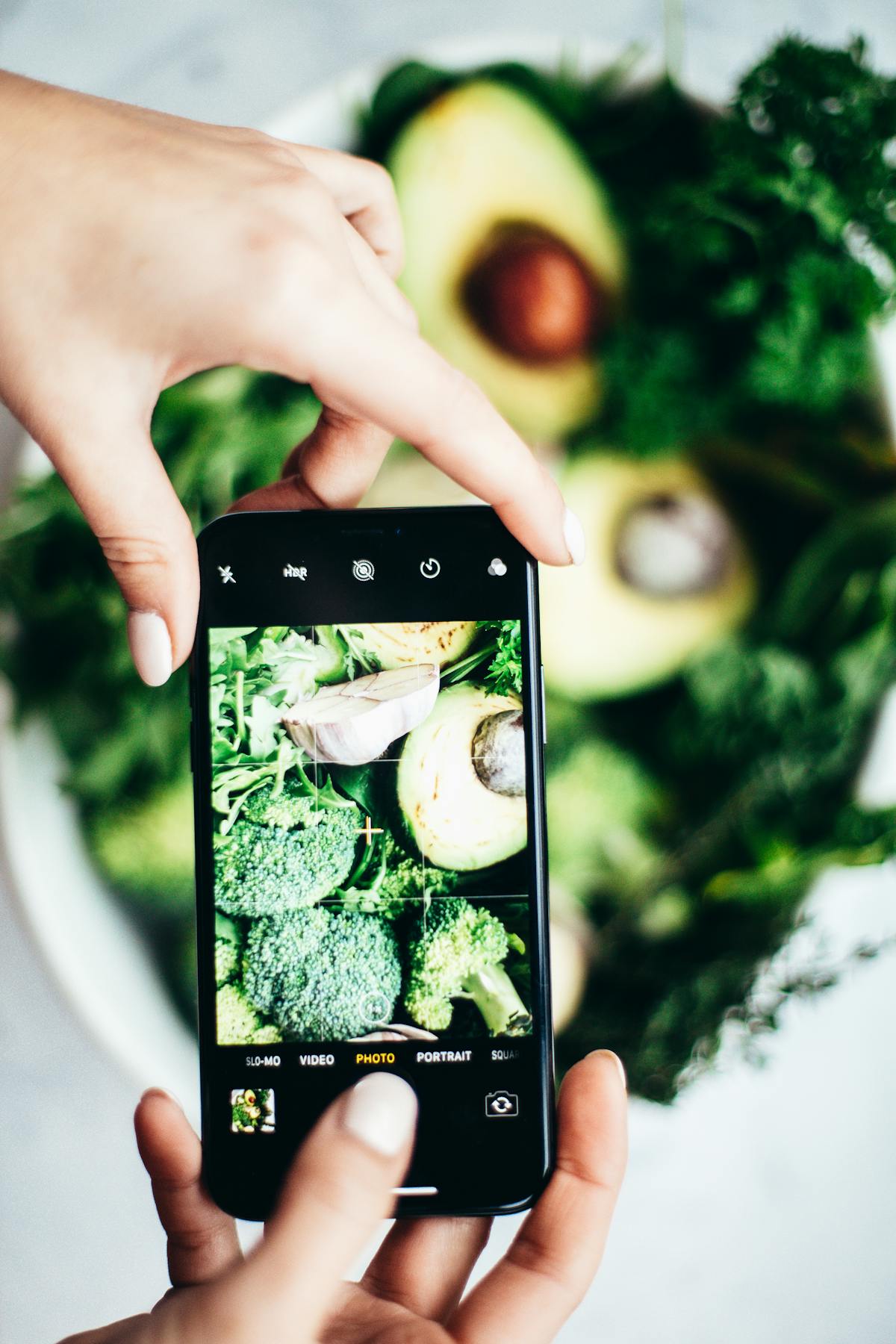 Colorful high-protein snack board with vegetables, dips, cheese, and crackers arranged on a wooden platter
