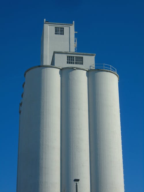 Free A Grain Elevator under a Clear Blue Sky Stock Photo