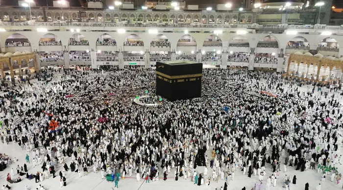 Crowds of pilgrims performing Tawaf around the Kaaba in Masjid al-Haram at night