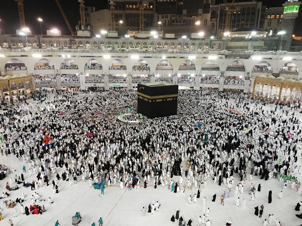 Free From above of crowded square around Kaaba cube in Great Mosque of Mecca at night time Stock Photo
