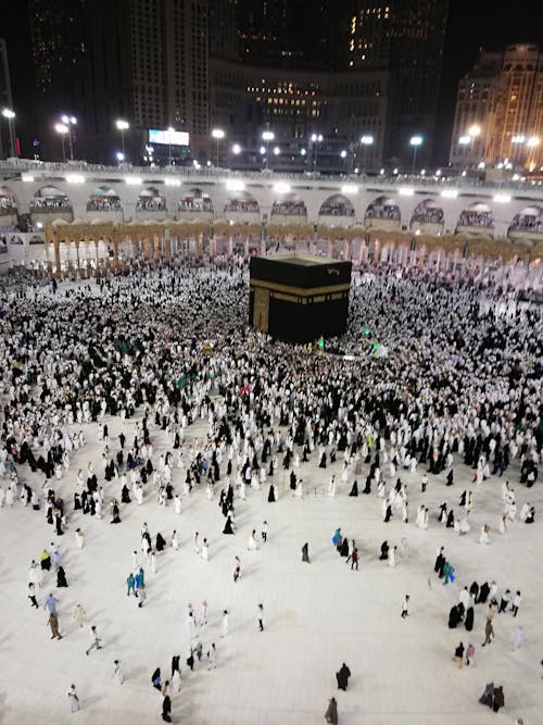 From above of Muslim prayers visiting Kaaba sanctuary during pilgrim journey to Mecca