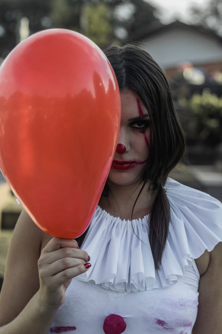 Sad Woman In Clown Outfit With Red Balloon