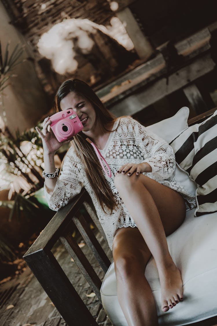 Candid Woman Holding A Polaroid Camera