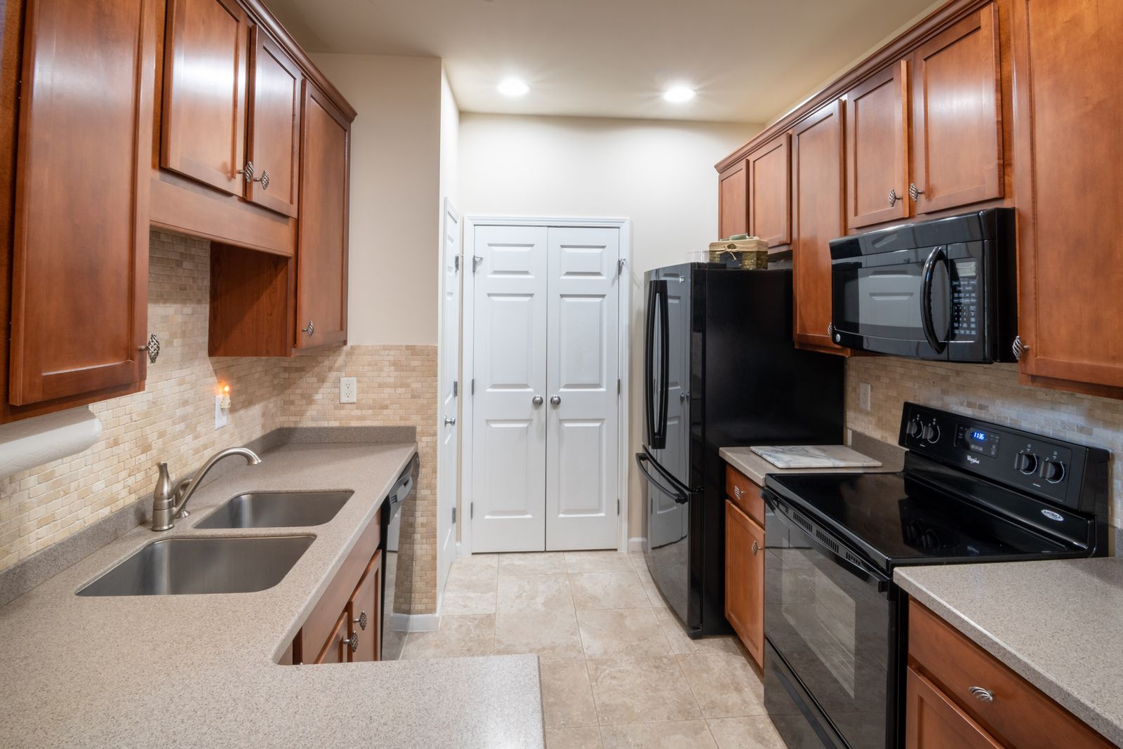 Modern kitchen with double bowl stainless steel sink and wood cabinets