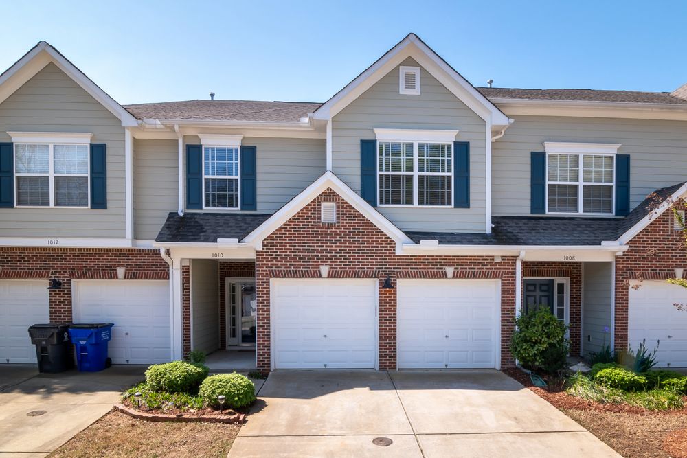Concrete driveways serving brick suburban homes