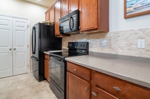 Marble Top Kitchen Counter With Wooden Cabinets