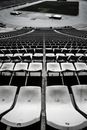 High angle black and white runner stadium empty seat rows above race tracks