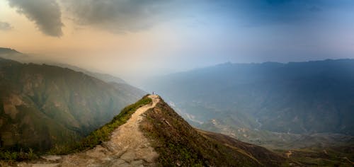 Person Standing on Brown Mountain