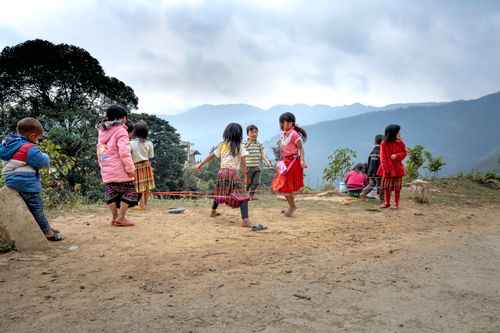 Free Joyful children engaging in traditional outdoor games in a rural area. Stock Photo