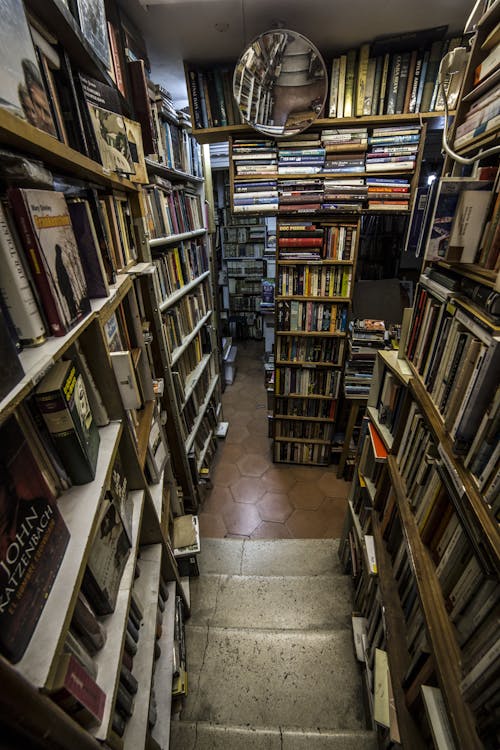 Free Old fashioned bookstore with aged shelves loaded with assorted various books and magazines Stock Photo