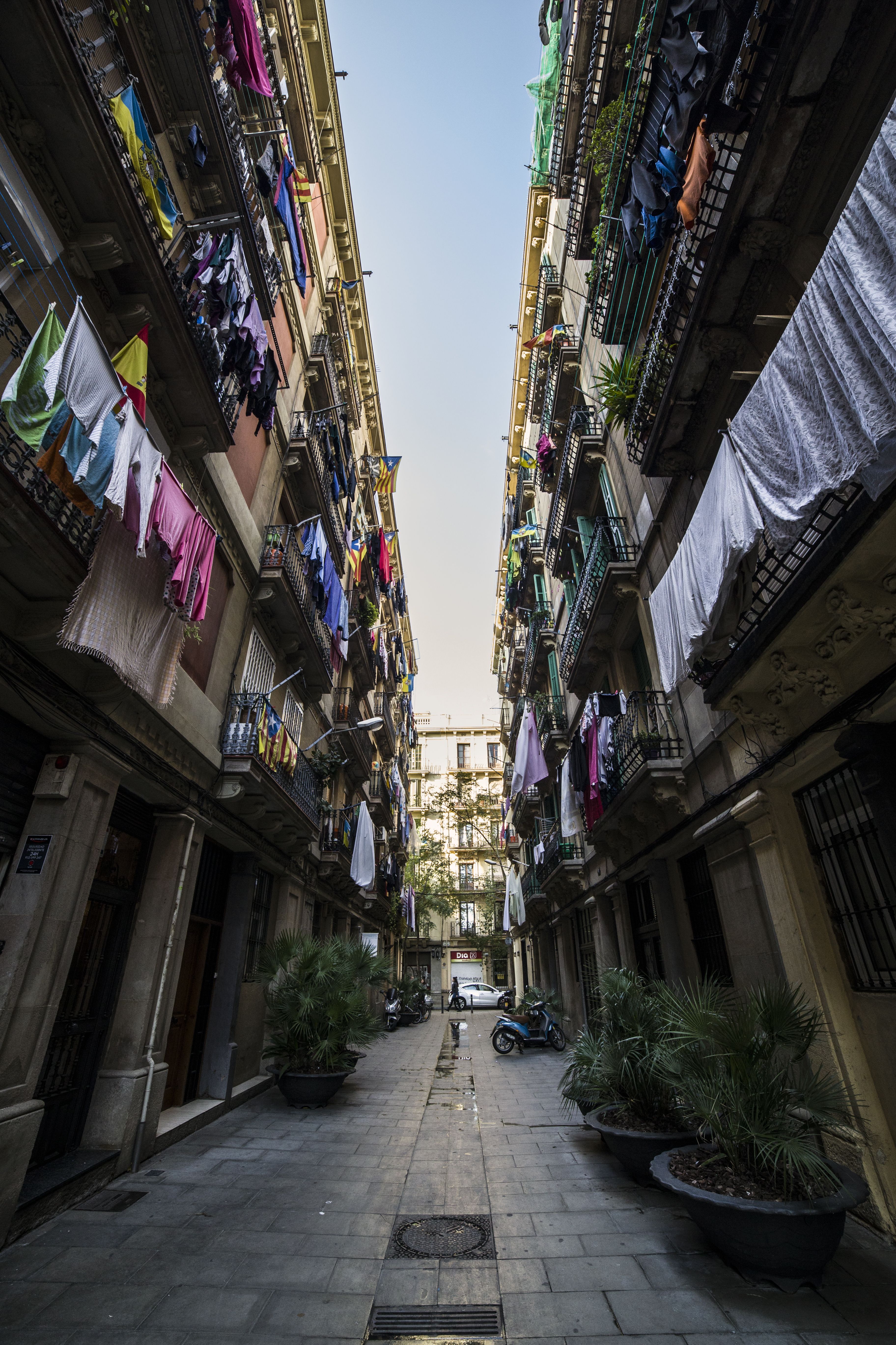 Exterior houses on narrow street with drying laundries on balconies