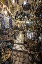 Interior of traditional oriental market stall with various authentic lamps and souvenirs hanging on walls or heaped on stands
