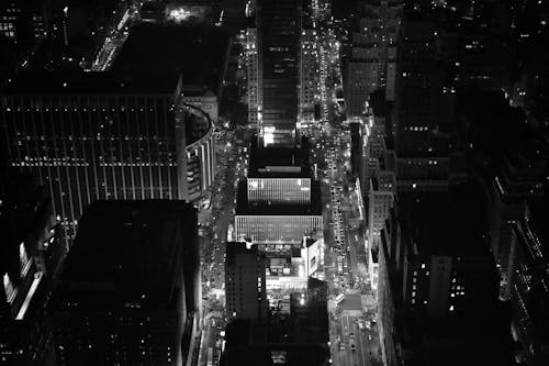 Free From above black and white picturesque contemporary skyscrapers located in downtown district illuminated by light at night Stock Photo