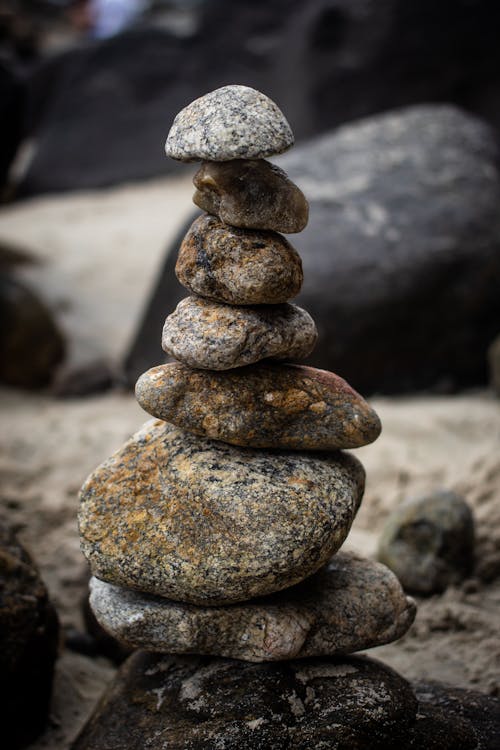 Closeup of rough stones placed on top of each other during performing rock balancing on beach