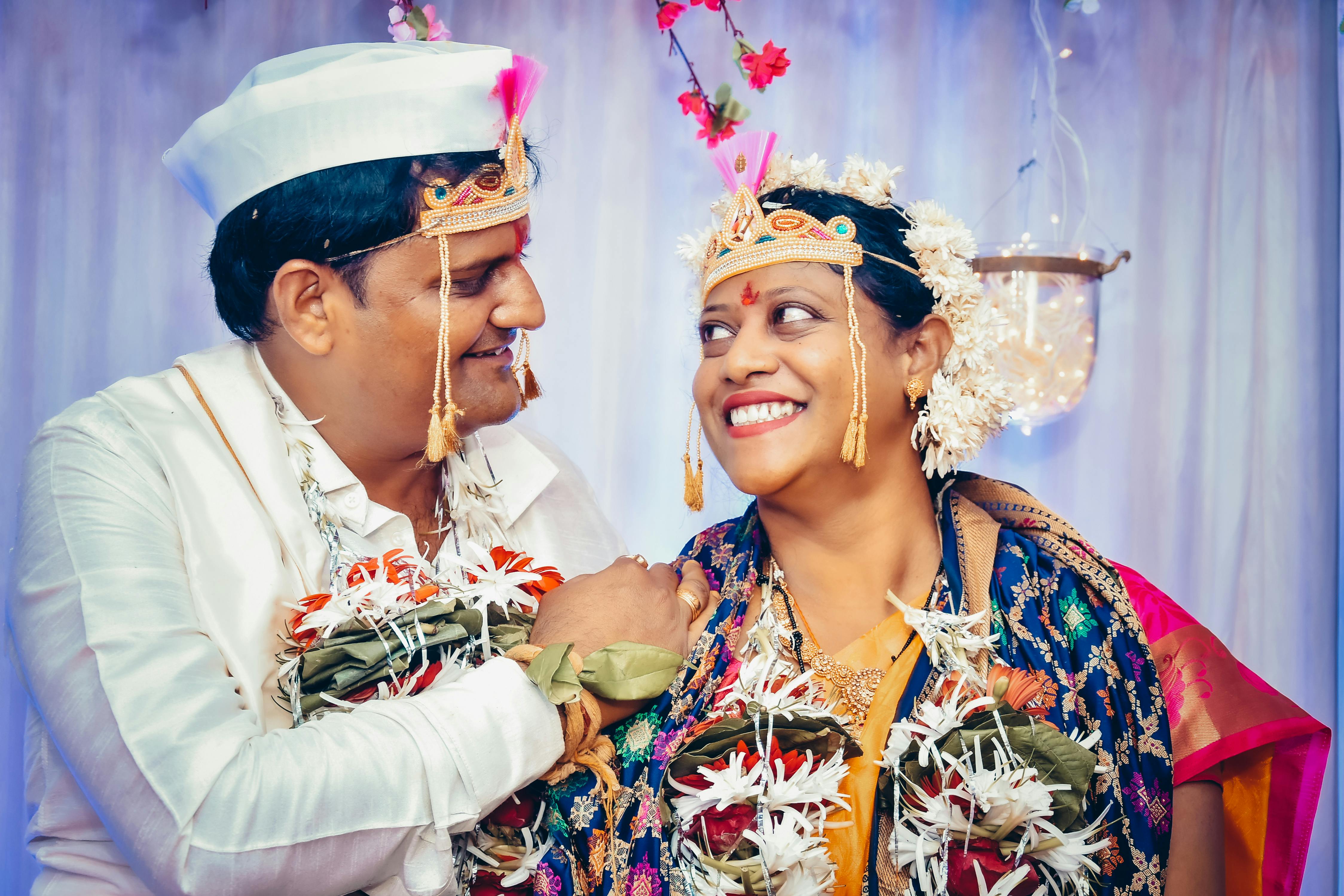 cheerful indian couple smiling during wedding celebration