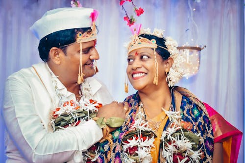 Cheerful Indian couple smiling during wedding celebration