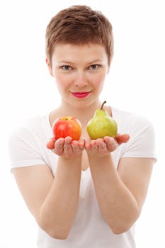 Woman Holding Red Apple and Green Peach