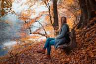 Photo Of Woman Sitting On Wooden Bench